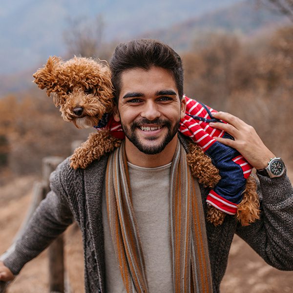 Man Hiking With Dog On Shoulders